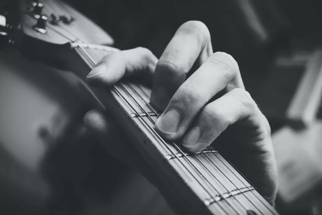 hand playing a guitar up-close shot